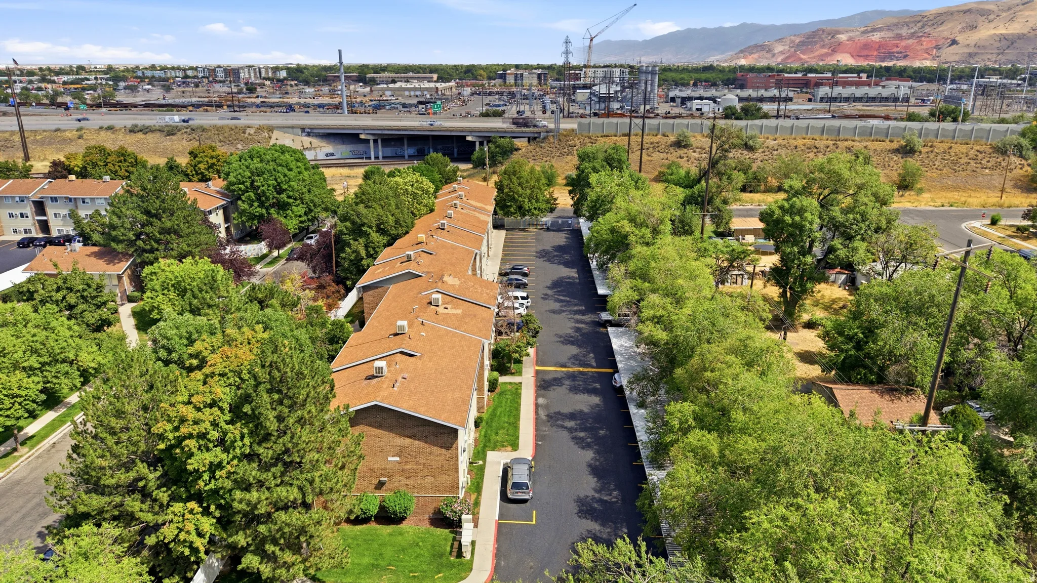 Apartment complex featuring brick facades and brown shingle roofs