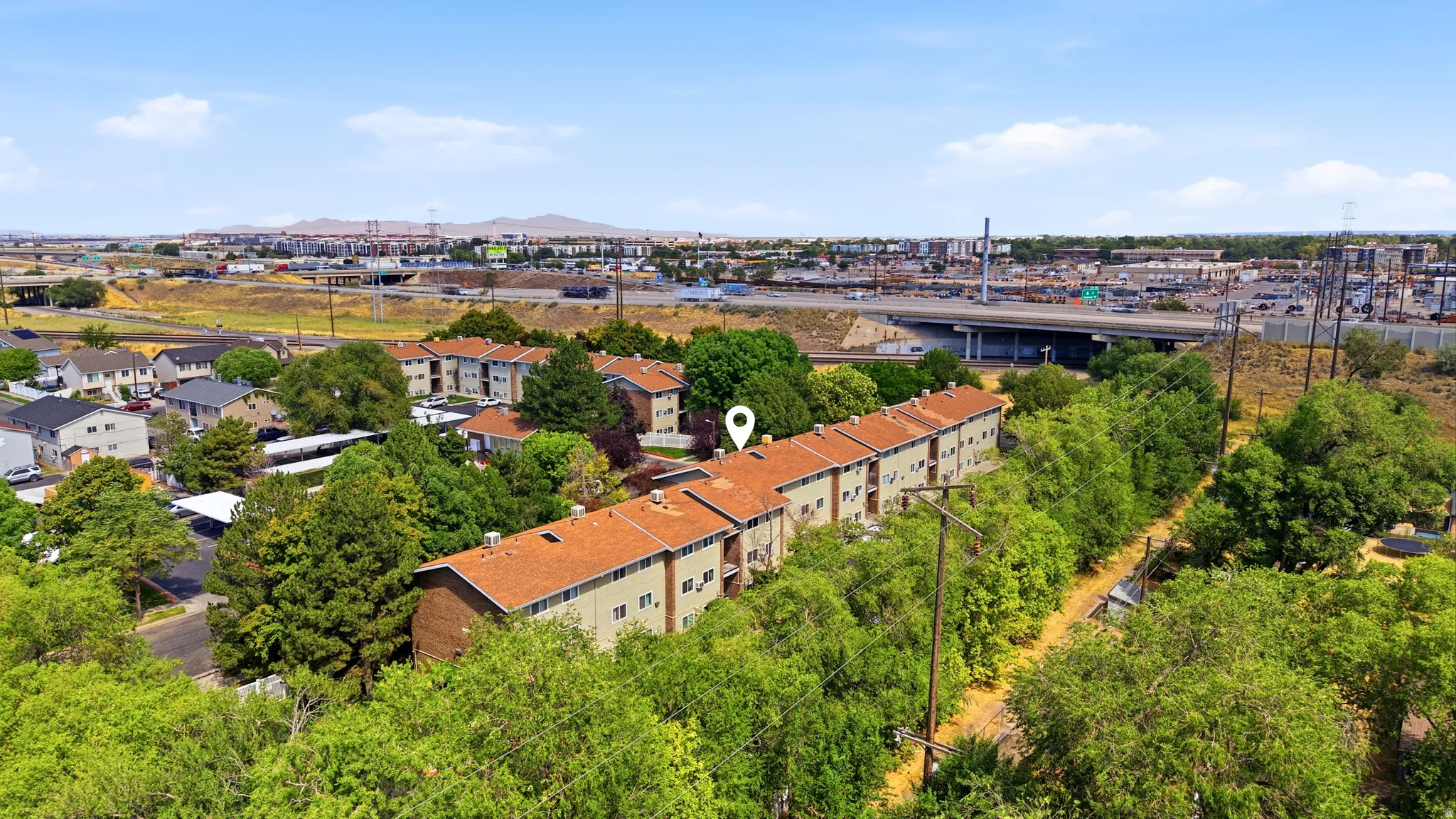 Multi-unit residential buildings featuring terracotta-style roofing and light-toned siding