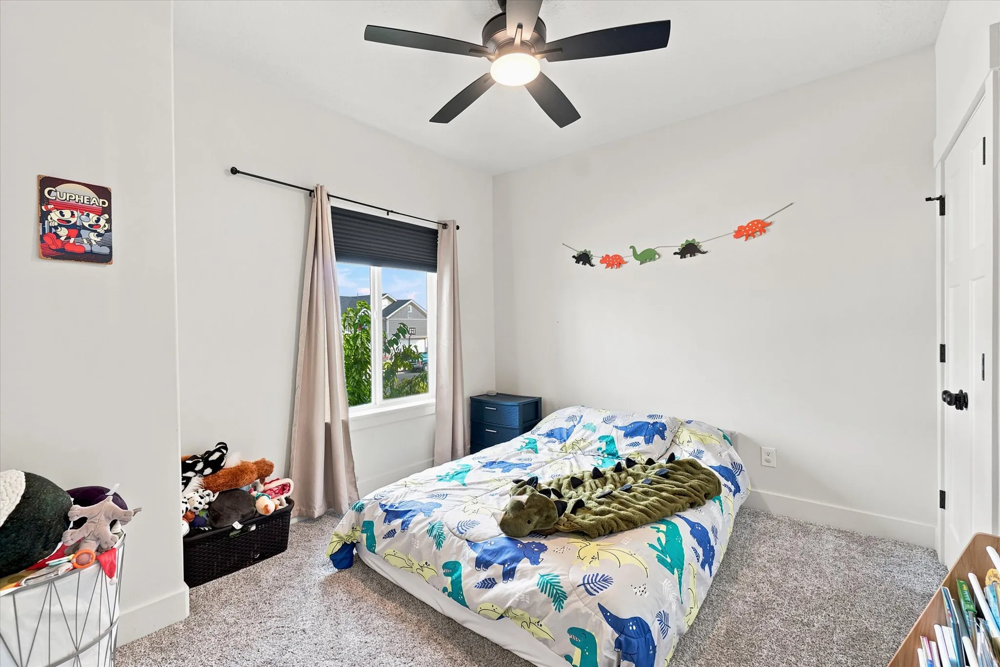 Bedroom featuring a ceiling fan with integrated lighting, a window with blinds and drapes, and neutral wall tones