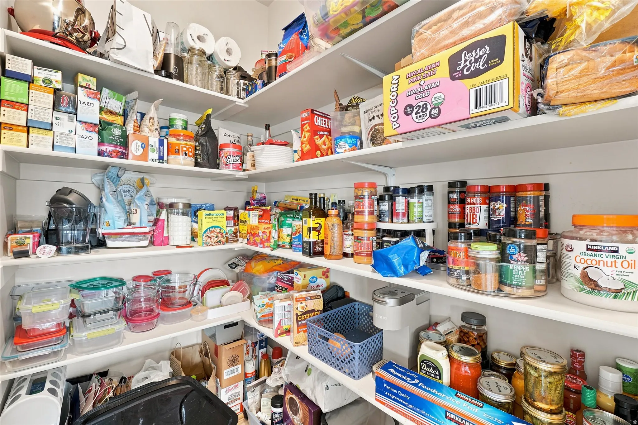 Walk-in pantry featuring extensive white shelving