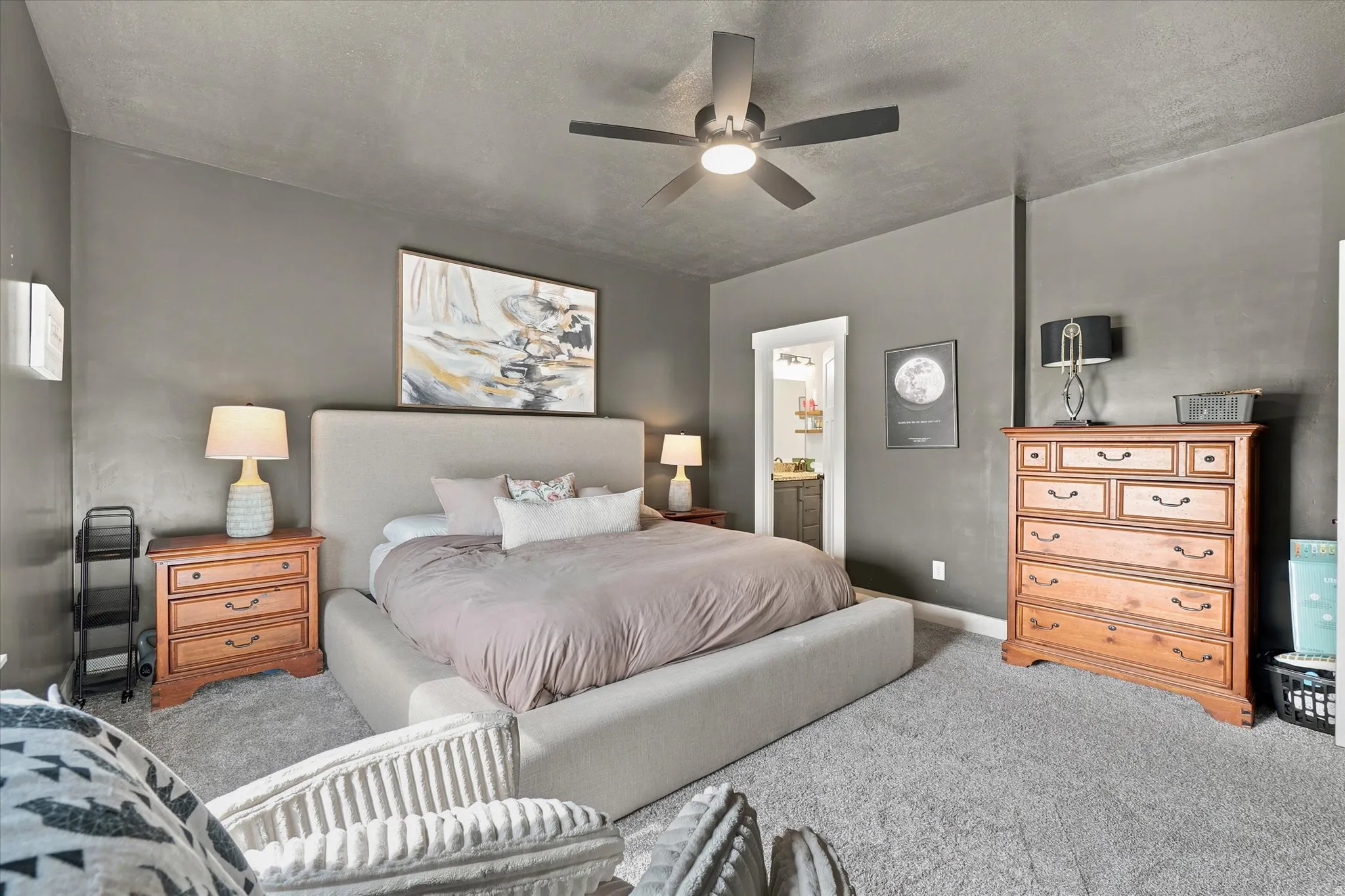 Spacious bedroom featuring neutral wall tones and a textured ceiling