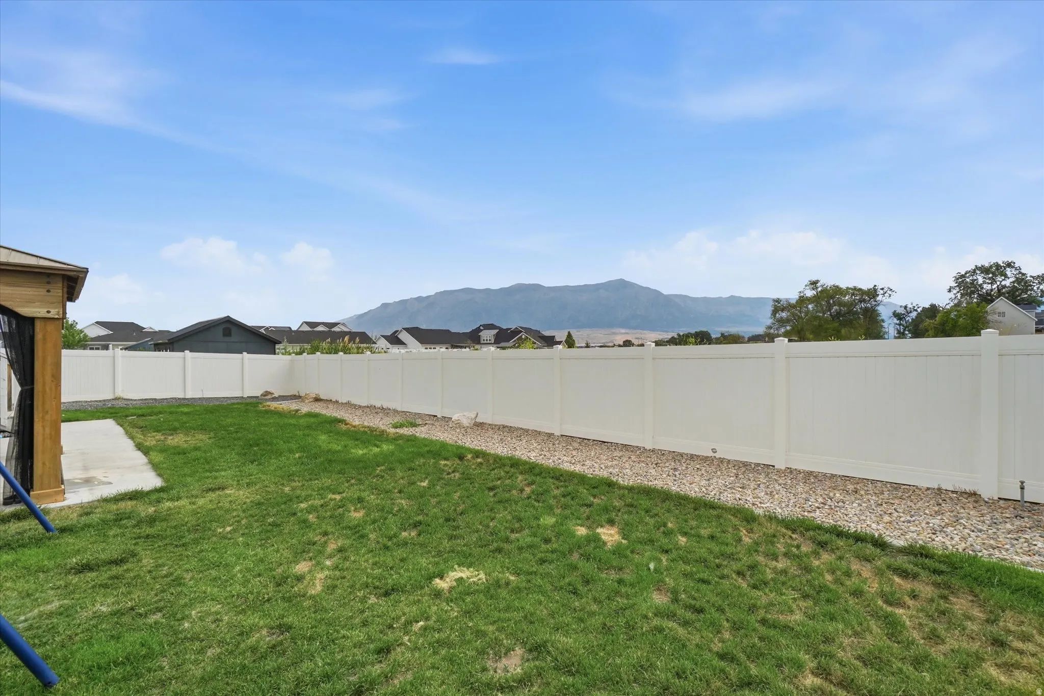 Expansive grassy yard with a full privacy fence