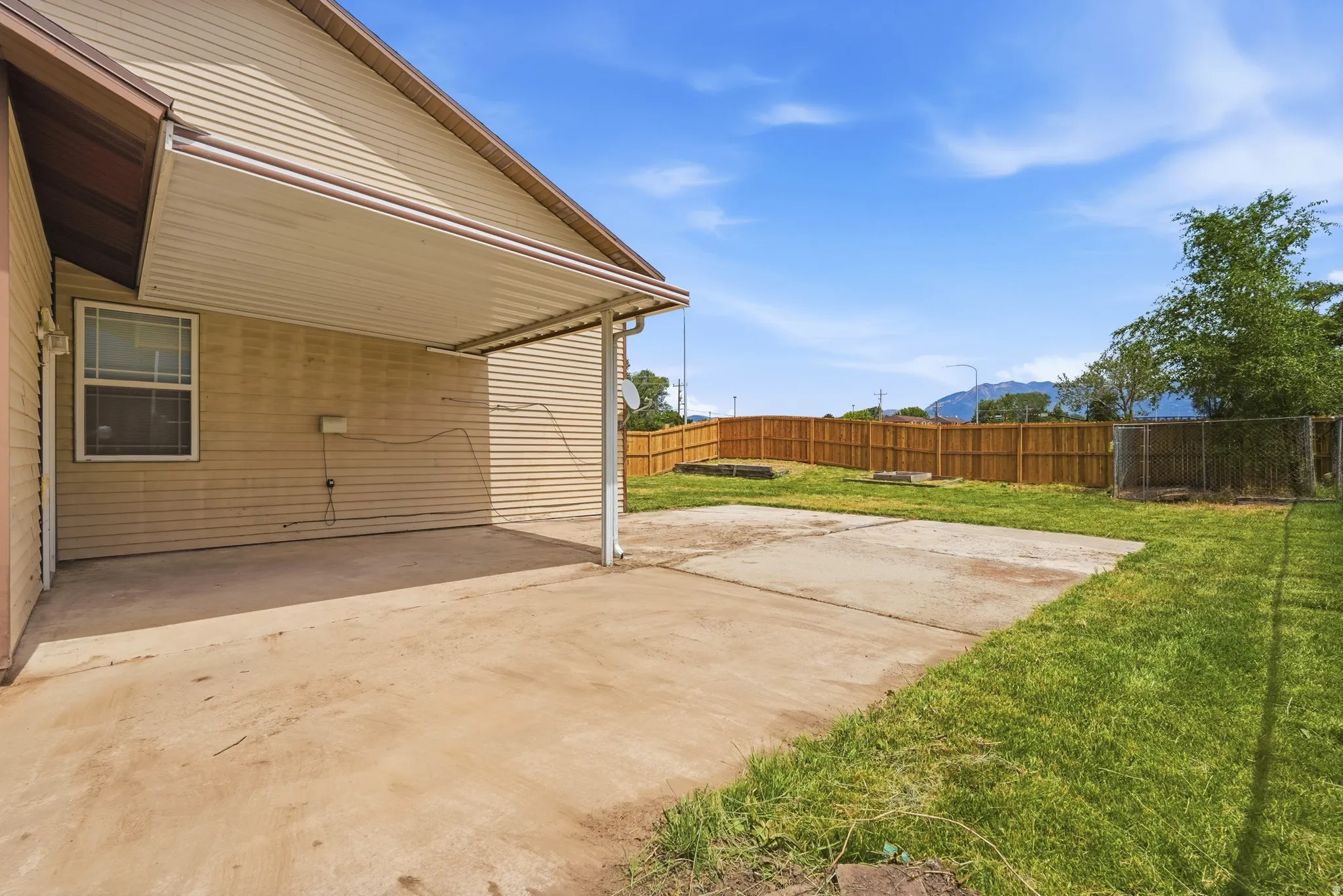 Covered patio with concrete flooring, siding exterior, and a fenced backyard