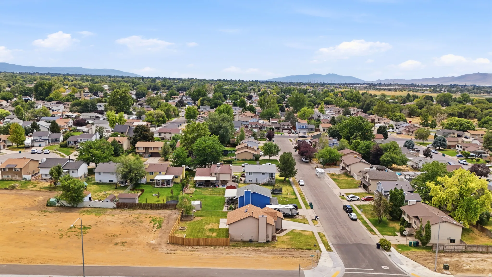 Established residential area with tree-lined streets and distant mountain scenery