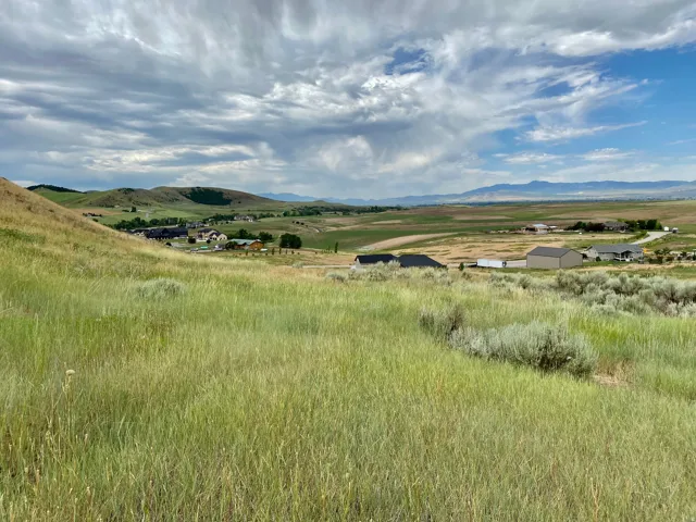 Expansive undeveloped land with rolling hills and distant mountain ranges