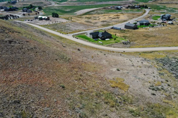 Expansive undeveloped lot featuring natural prairie grasses and a gentle slope
