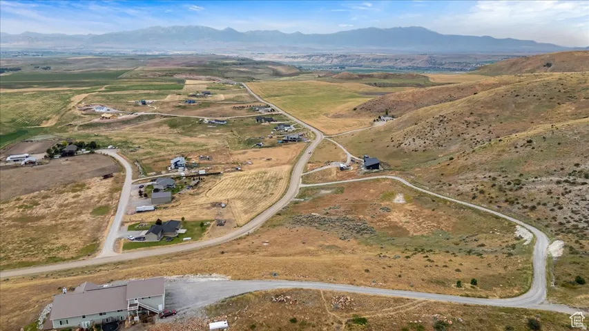 Expansive aerial perspective showcasing rolling hills and scattered residential properties