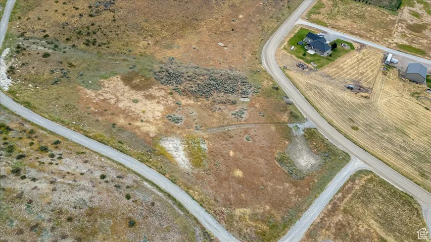 Expansive land parcel featuring natural terrain and visible road access