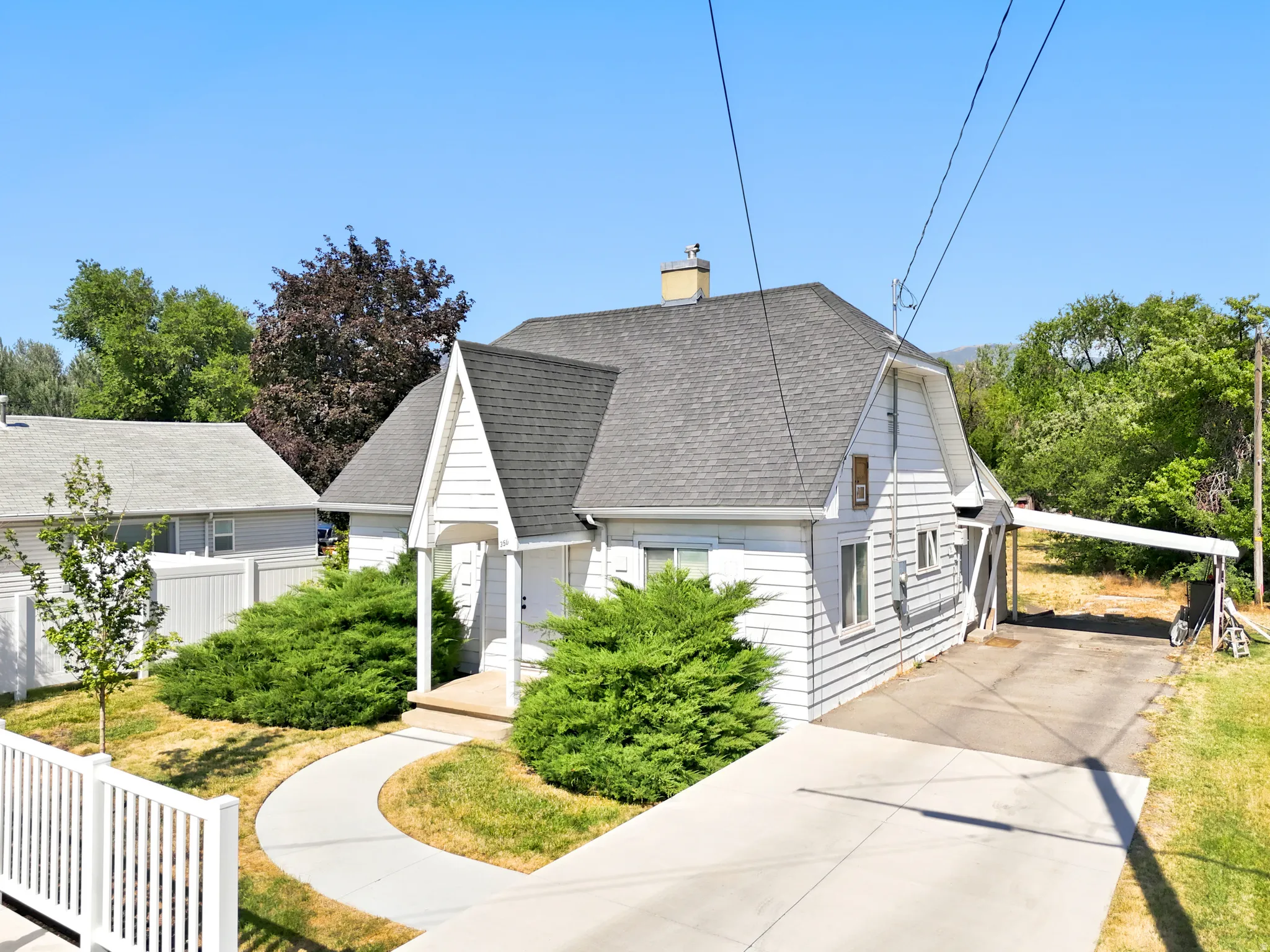 White siding exterior with a prominent gabled entry