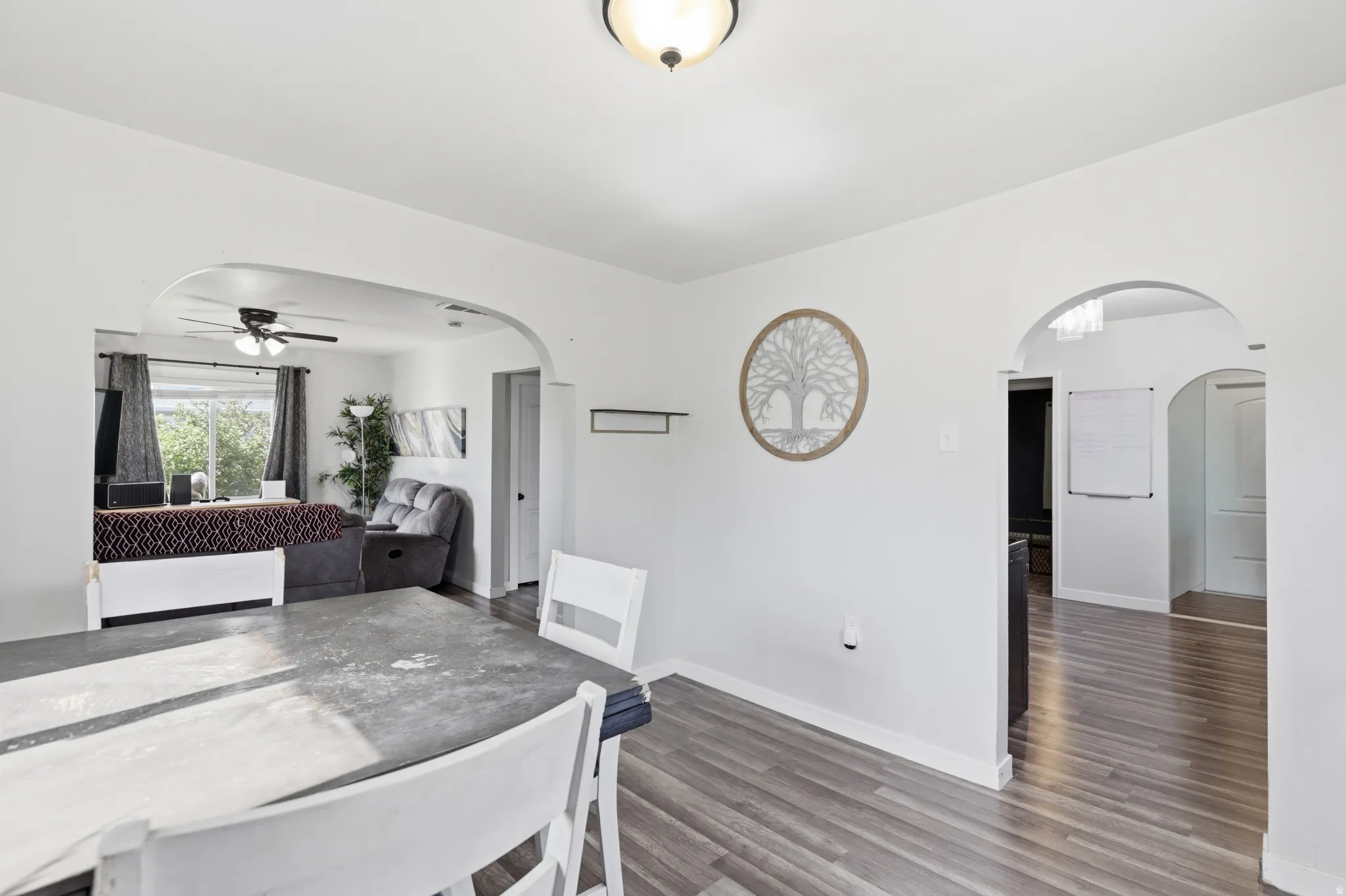 Bright interior spaces featuring light wood-finish flooring and arched doorways
