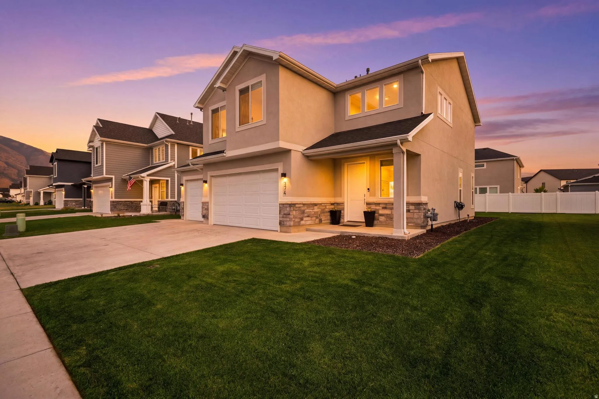 Contemporary two-story residence with a stucco and stone veneer exterior