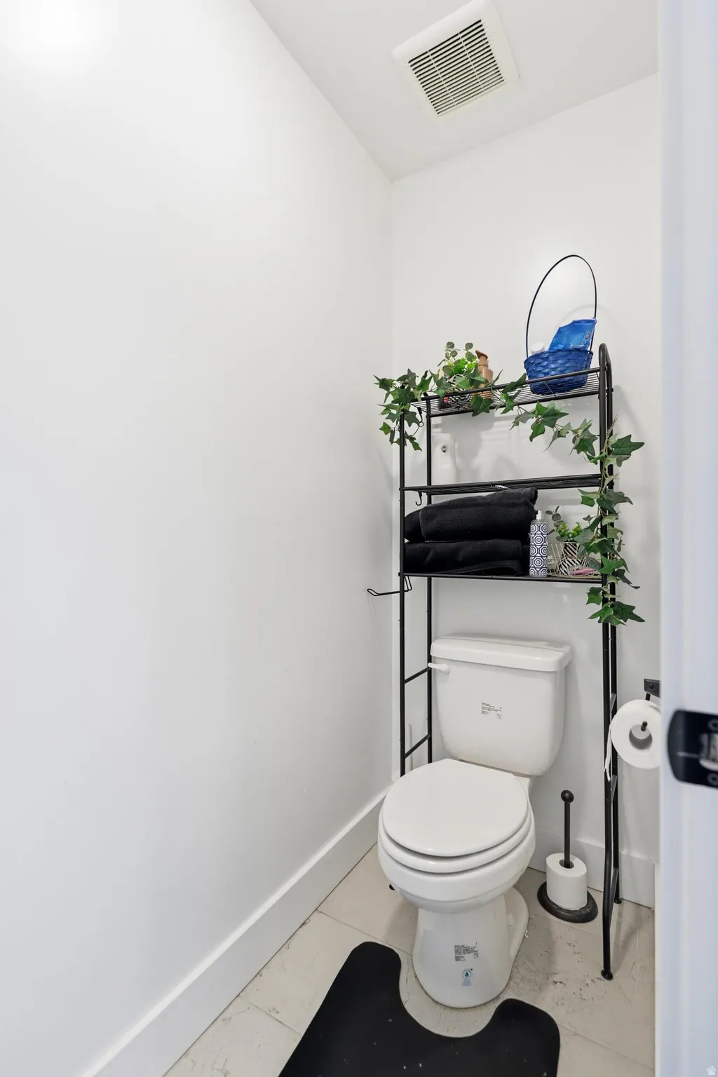 White toilet with a white tank in a compact space