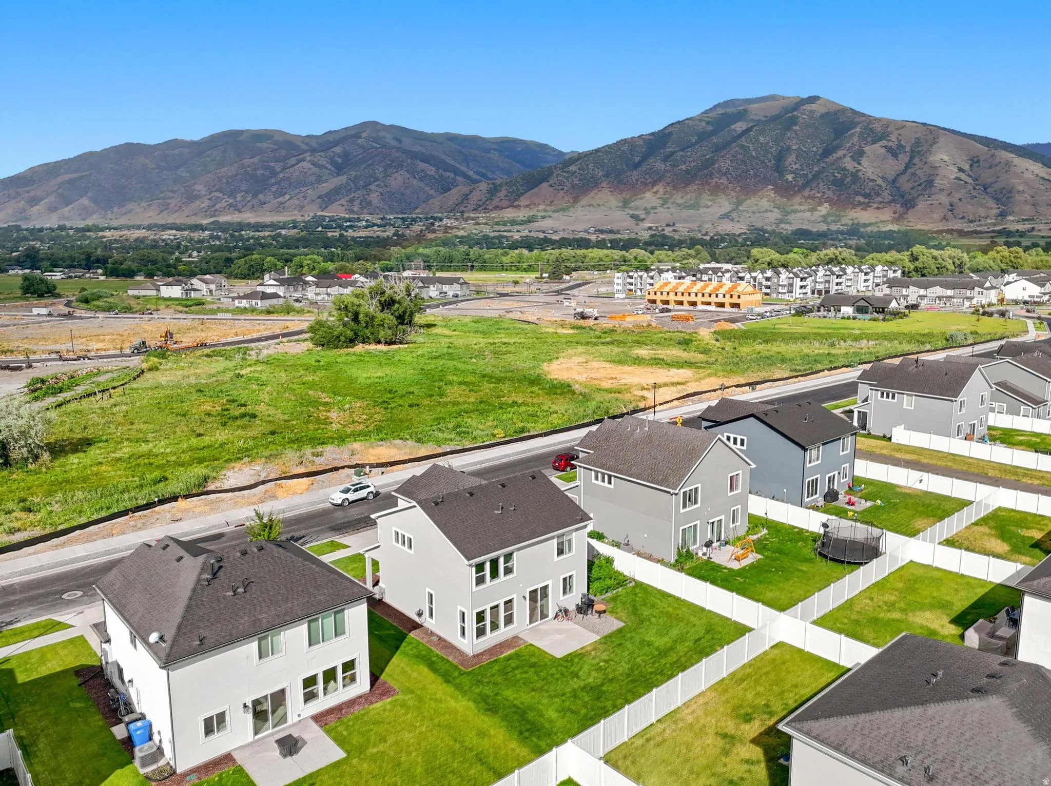 Aerial perspective showcasing a residential development with mountain scenery