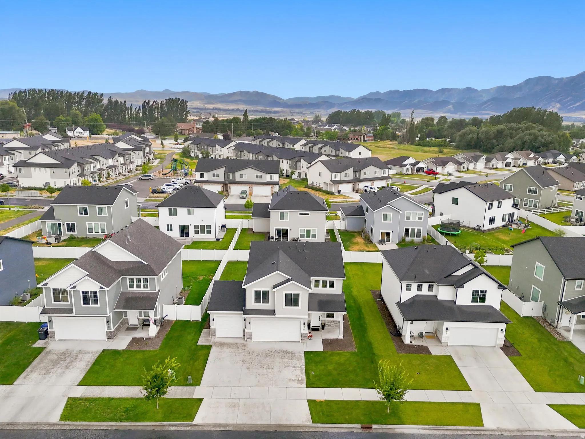 Contemporary residential neighborhood featuring well-maintained properties with manicured lawns and concrete driveways