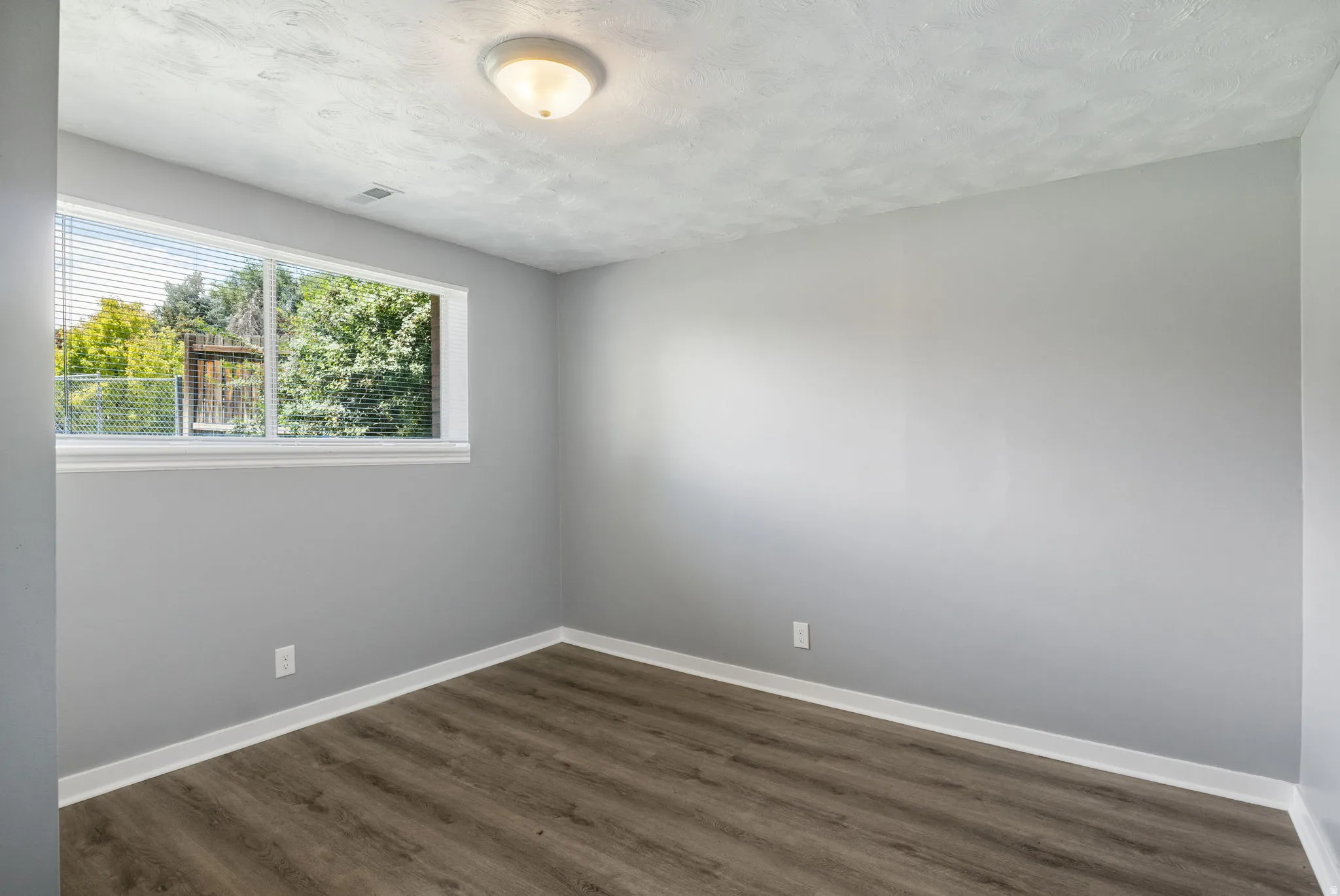 Neutral gray walls complement wood-finish flooring