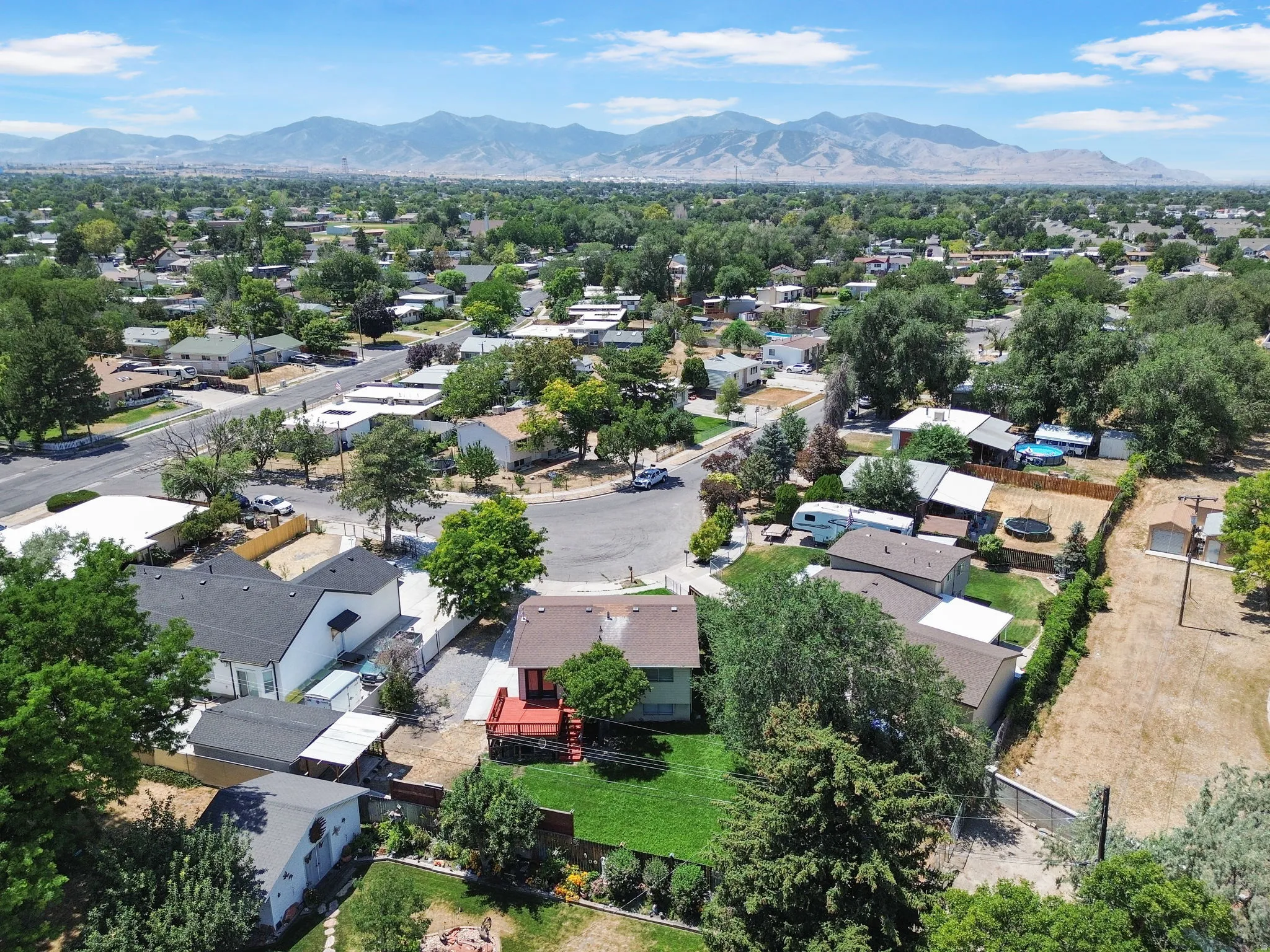 Aerial perspective showcasing a residential neighborhood with distant mountains