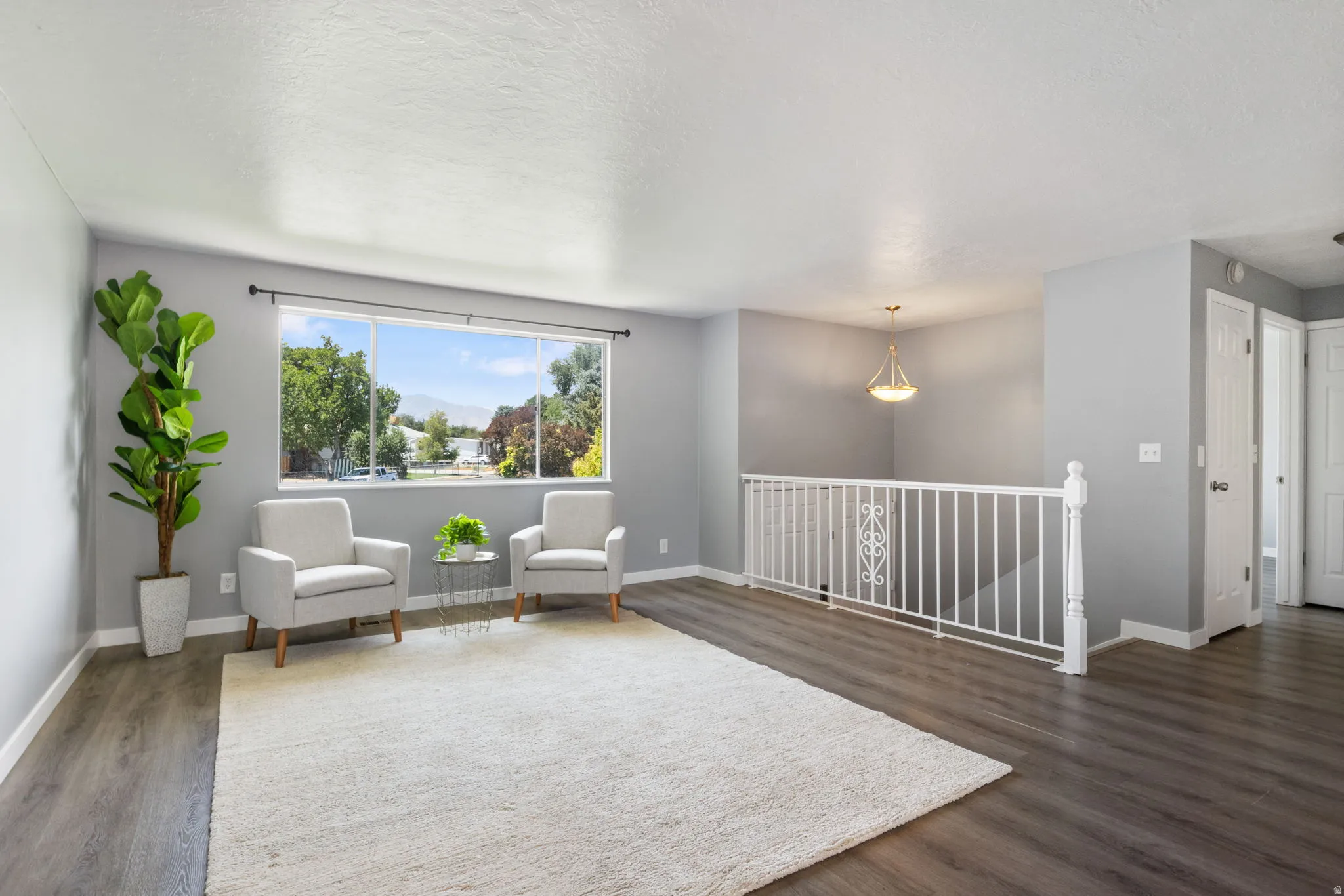 Spacious room featuring wood-finish flooring and a white trimmed window