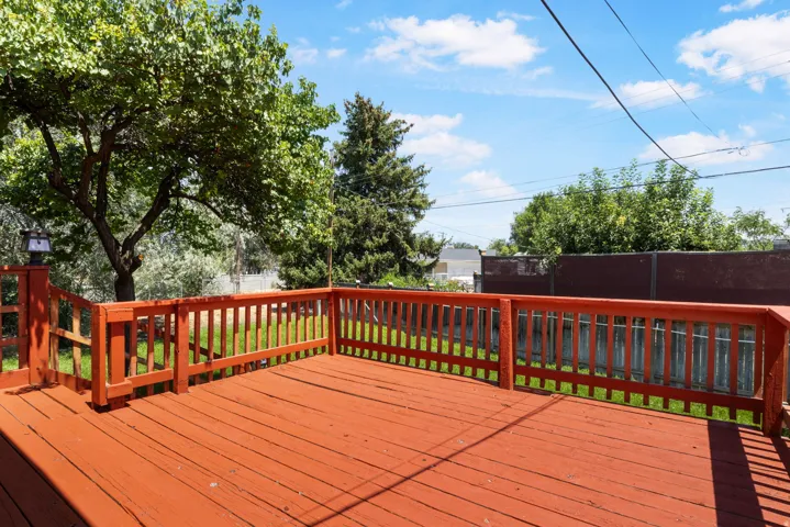 Expansive wood deck with a red finish and baluster railing