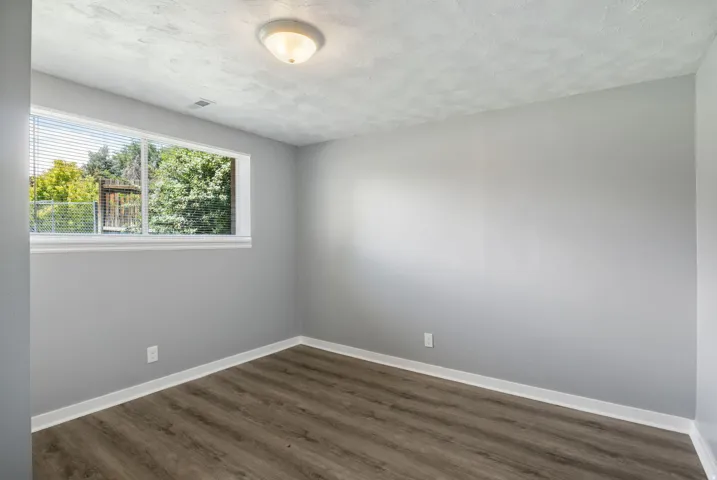 Neutral gray walls complement wood-finish flooring