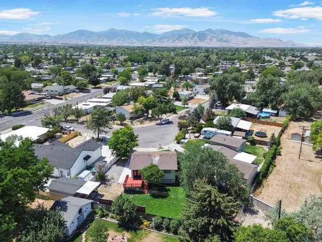Aerial perspective showcasing a residential neighborhood with distant mountains