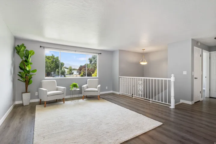Spacious room featuring wood-finish flooring and a white trimmed window