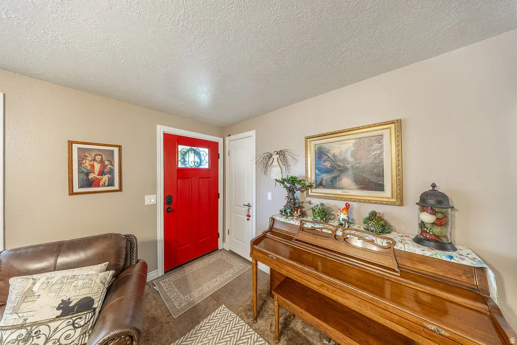 Vibrant red front door with decorative glass insert, complemented by neutral wall tones