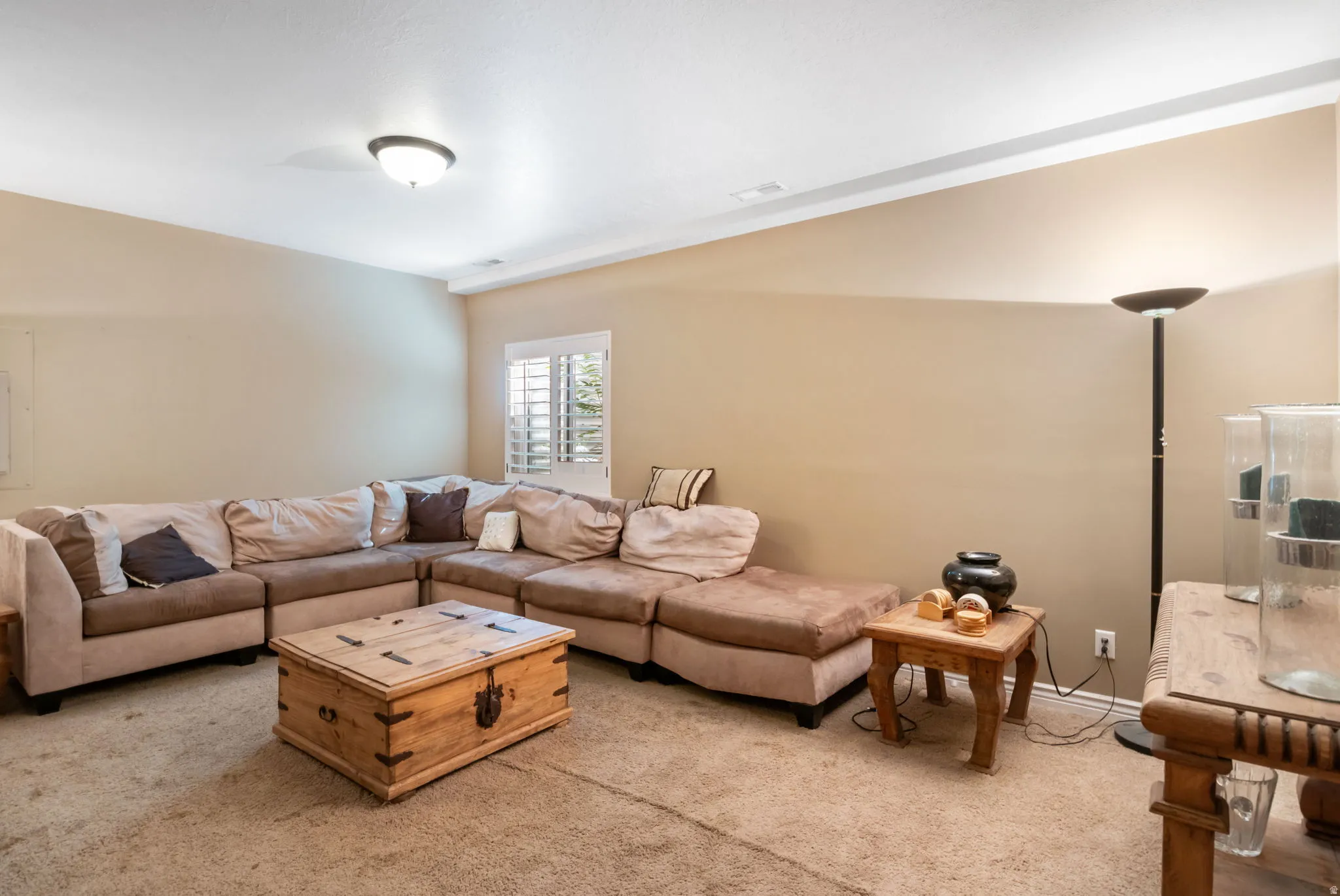 Spacious room with neutral wall tones and a ceiling-mounted light fixture