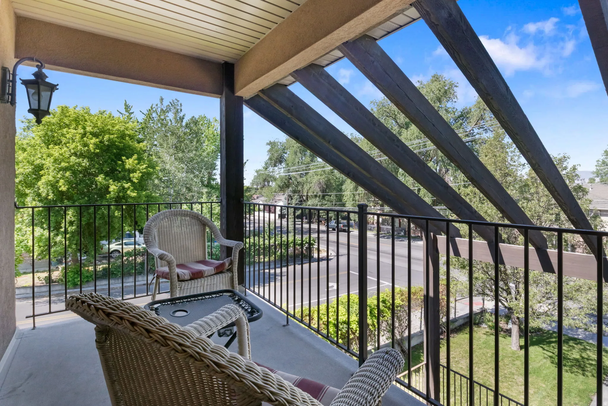 Private balcony featuring a black metal railing and a built-in outdoor light fixture