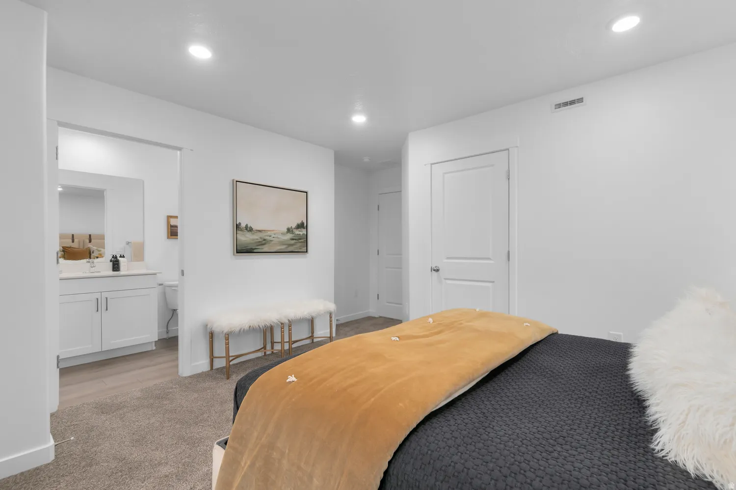 Carpeted bedroom featuring recessed lighting and a white paneled door