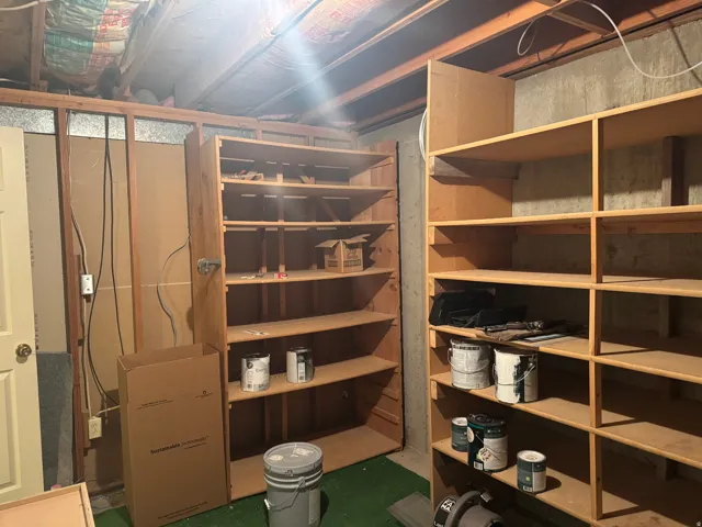 Unfinished basement area featuring exposed ceiling joists and wood framing