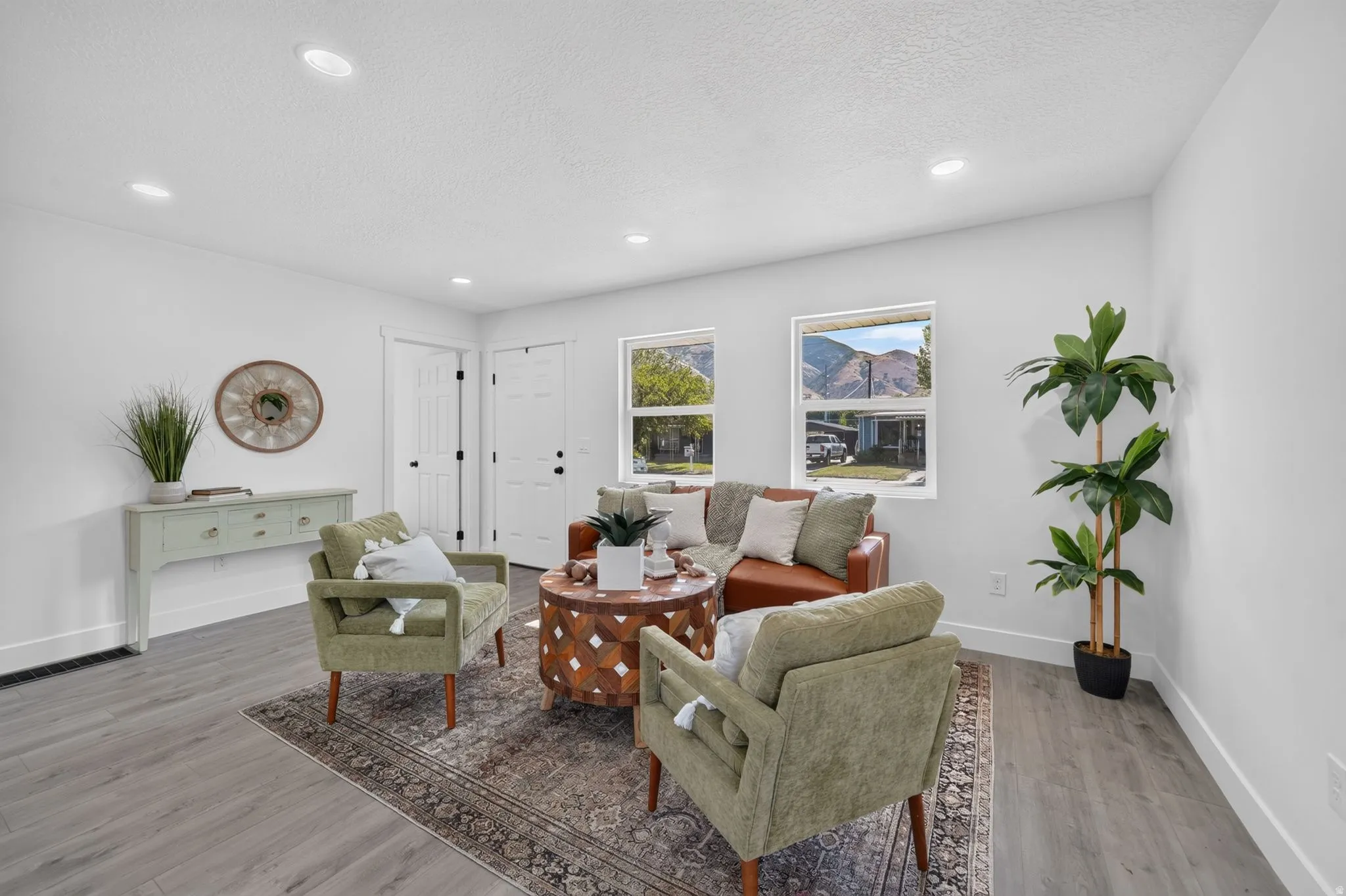 Spacious living area featuring wood-finish flooring, recessed lighting