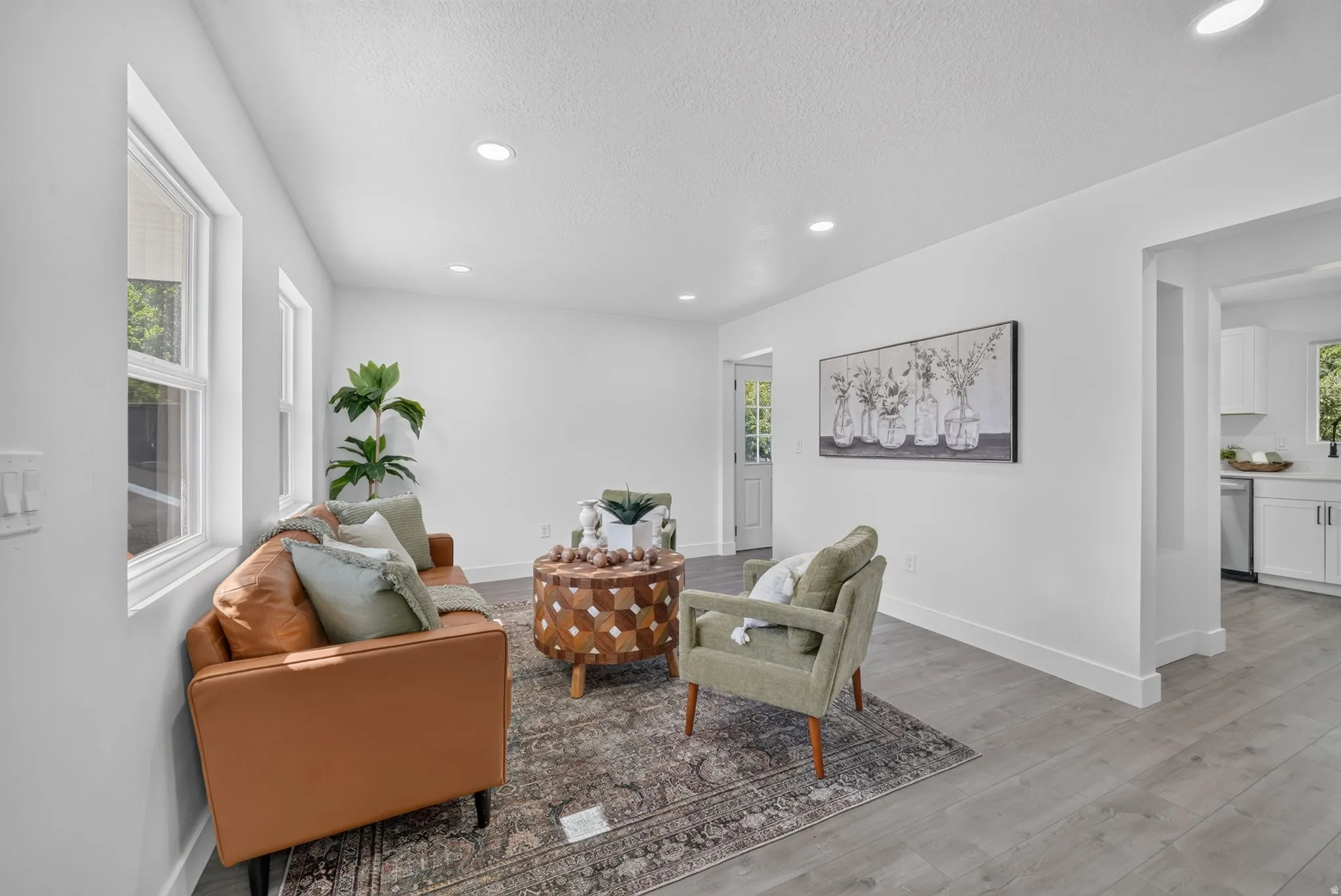 Bright interior space featuring recessed lighting, a neutral color palette, and wood-finish flooring