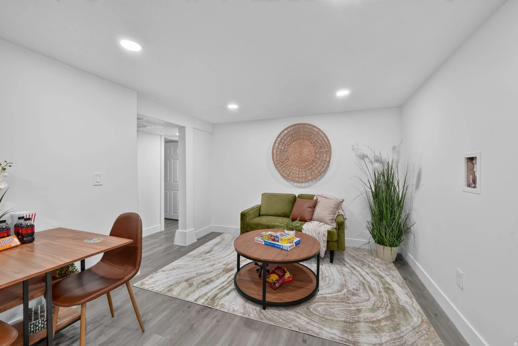Open-concept living space with recessed lighting and light wood-finish flooring