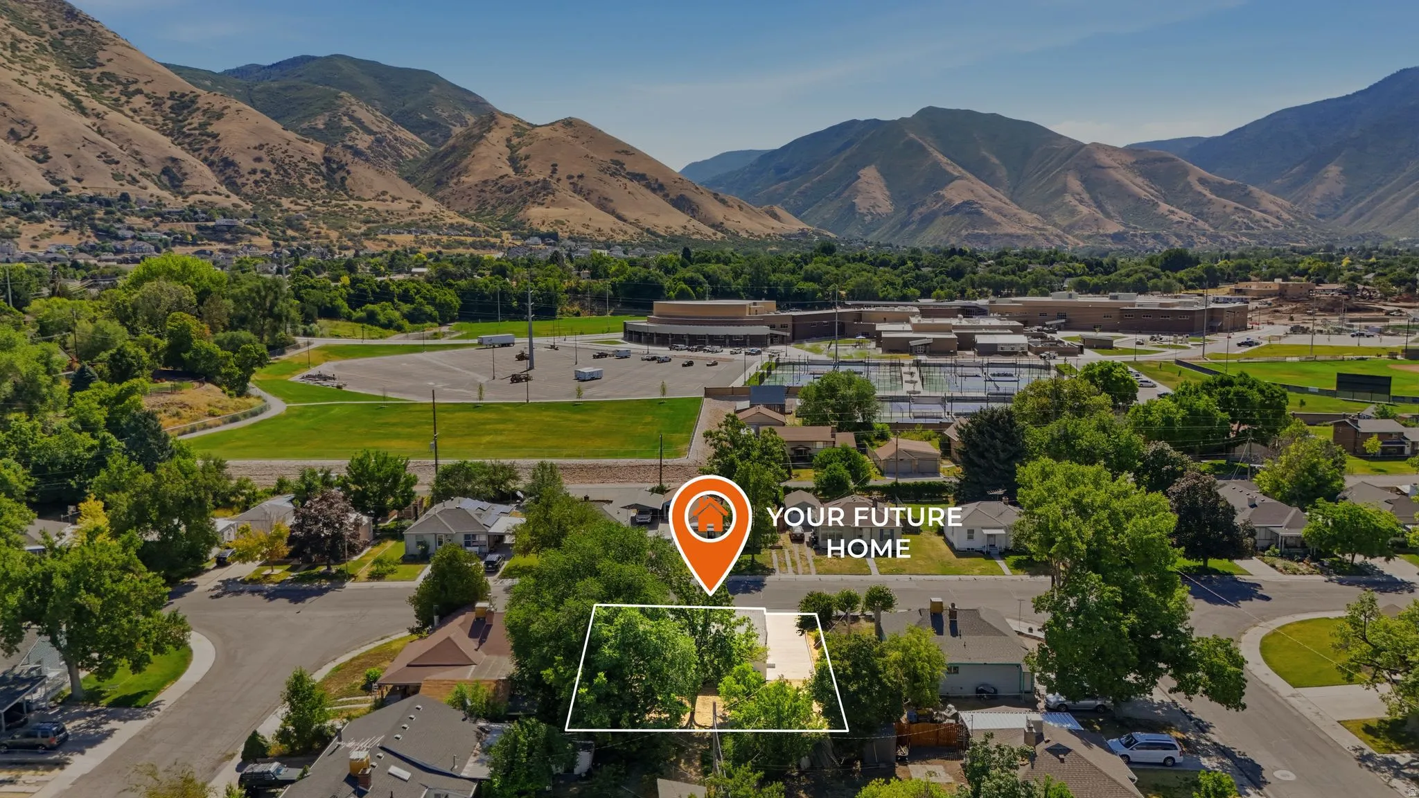 Aerial perspective showcasing a residential neighborhood with mountainous surroundings