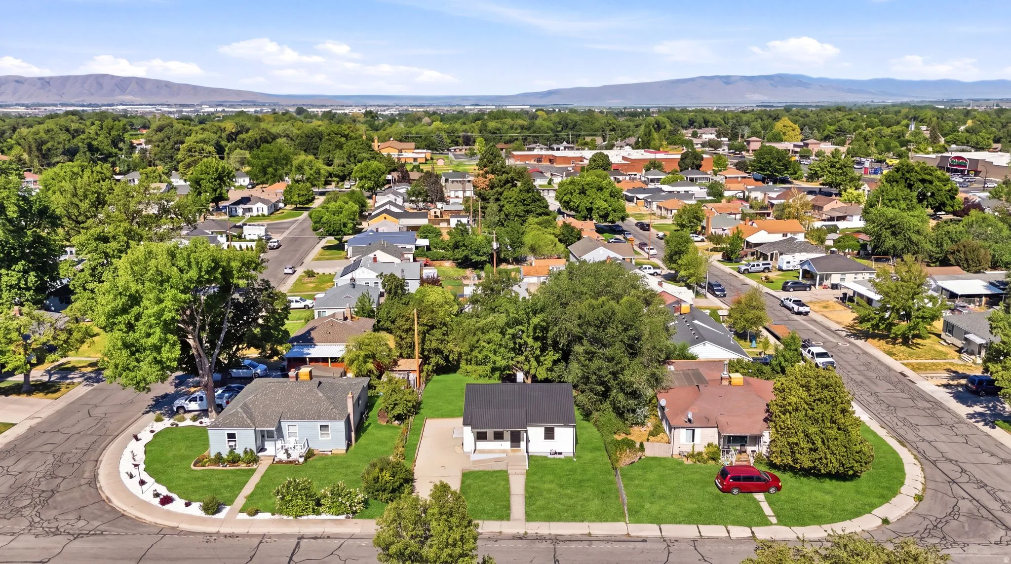 Aerial perspective showcasing a residential neighborhood with a mountain backdrop