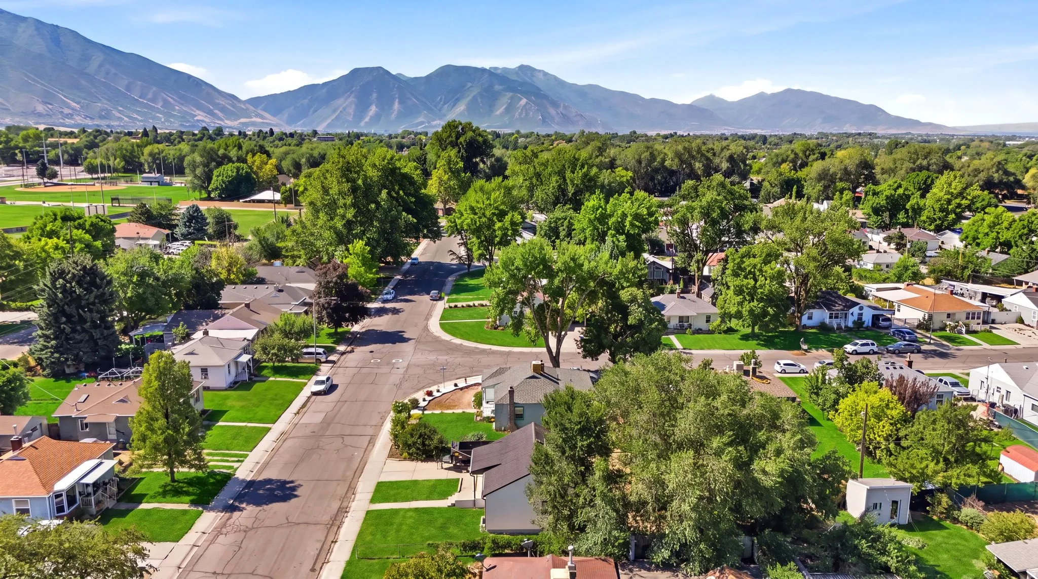 Tree-lined neighborhood featuring residential properties with mature trees