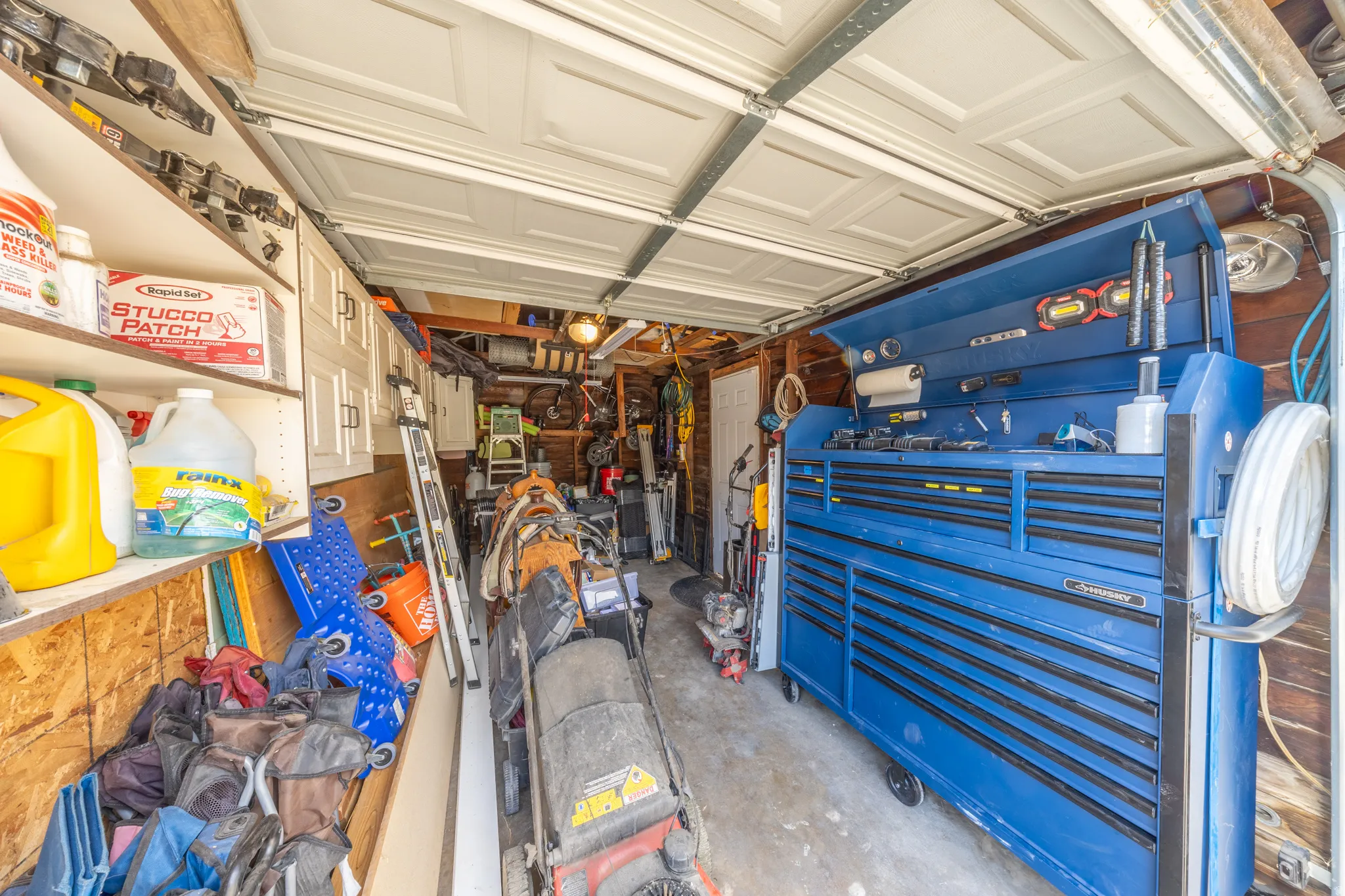 Attached two-car garage with overhead garage doors and built-in white cabinetry