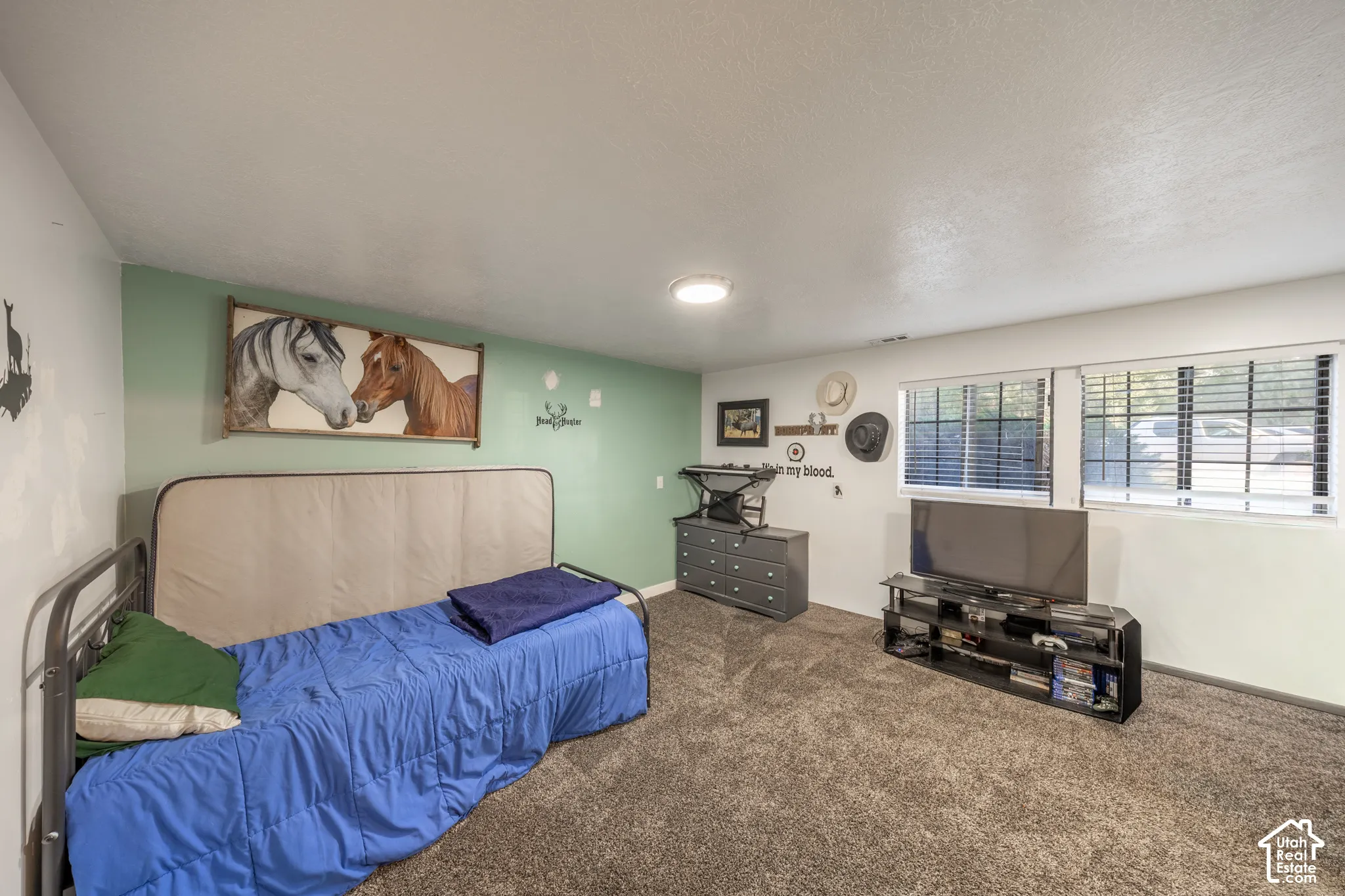 Wall-to-wall carpeting with light-toned walls, recessed lighting, and multiple windows with blinds