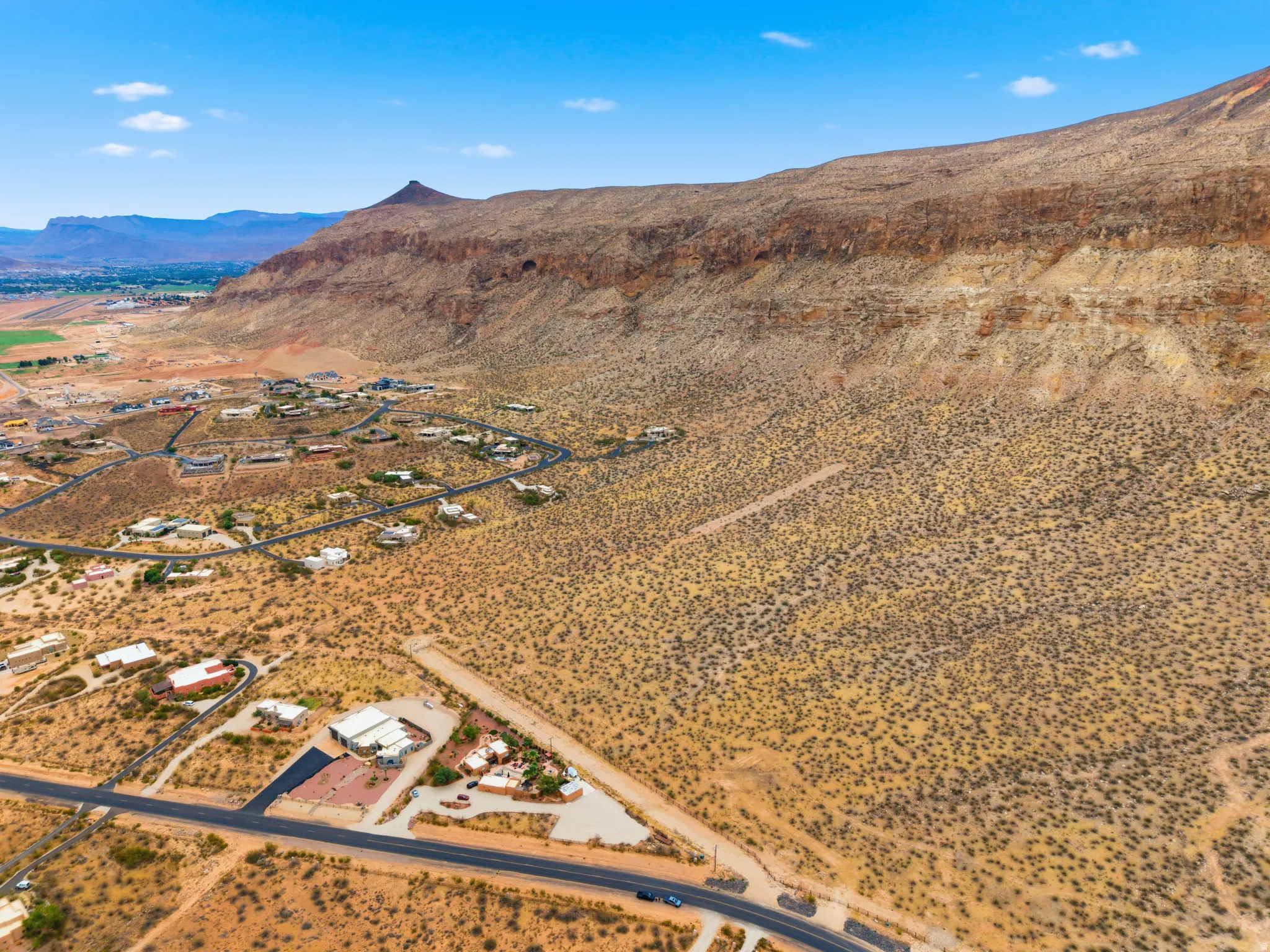Expansive aerial view showcasing a desert landscape with scattered residential properties