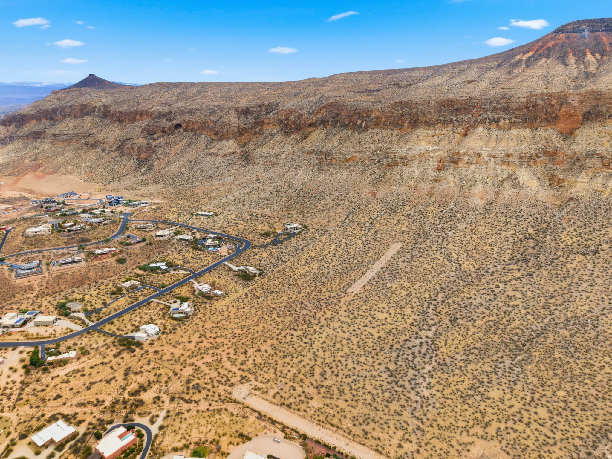 Expansive desert landscape with a rugged mountain backdrop