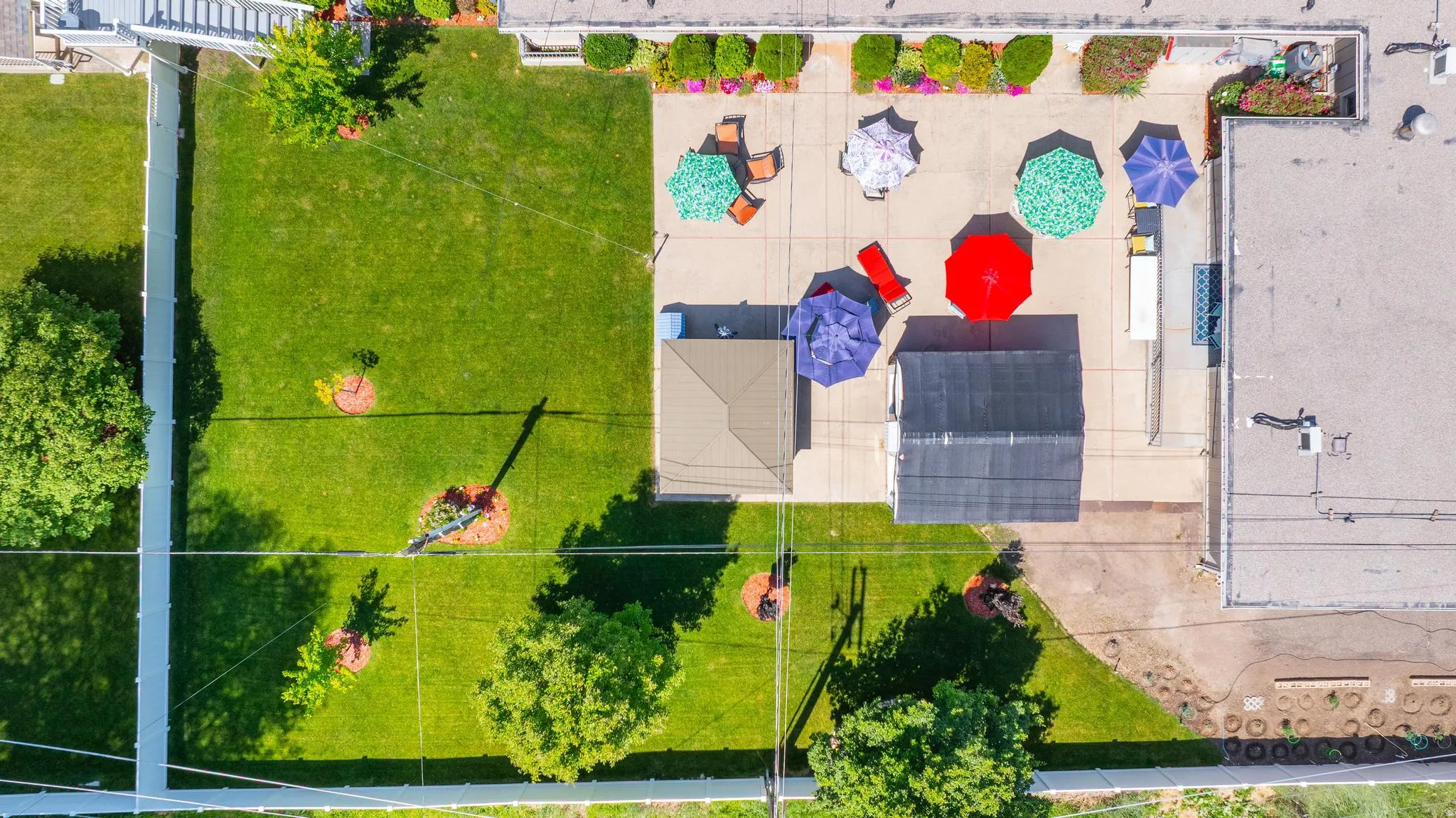 Expansive concrete patio with integrated garden beds