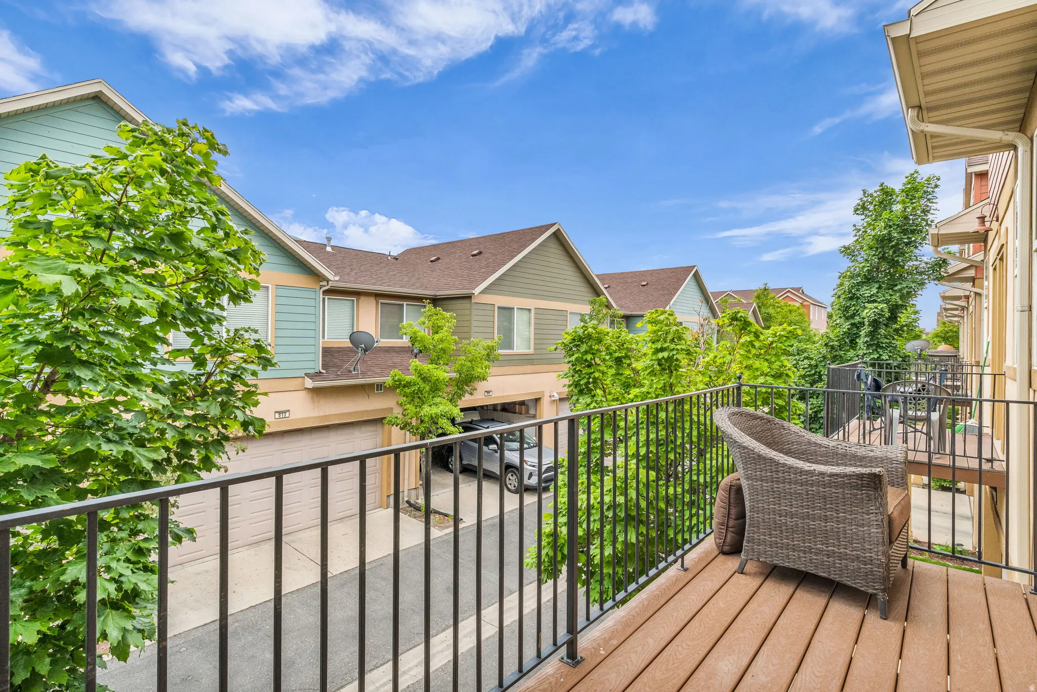 Private balcony featuring composite decking and a black metal railing