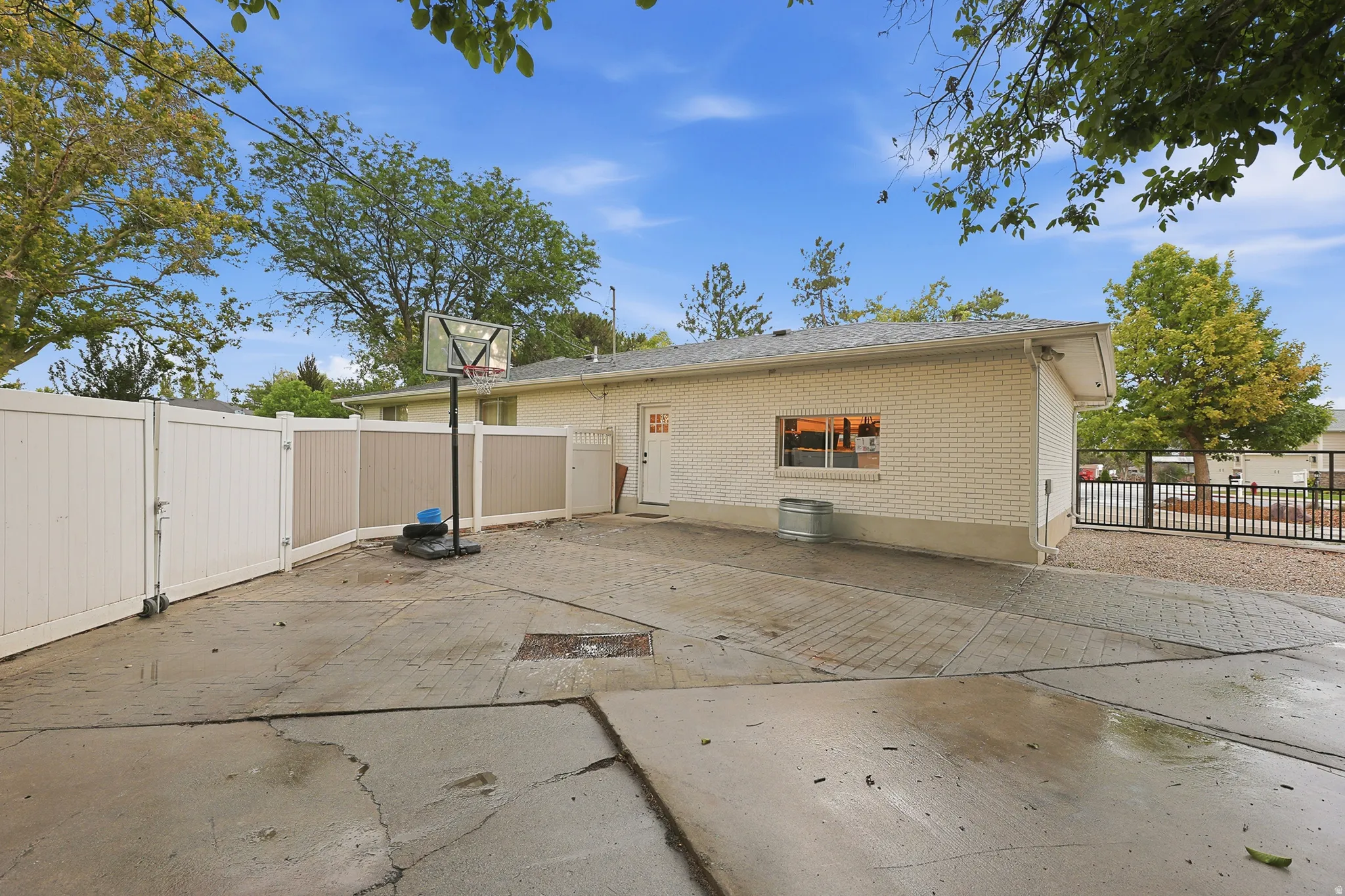 Expansive concrete patio with brick paver accents