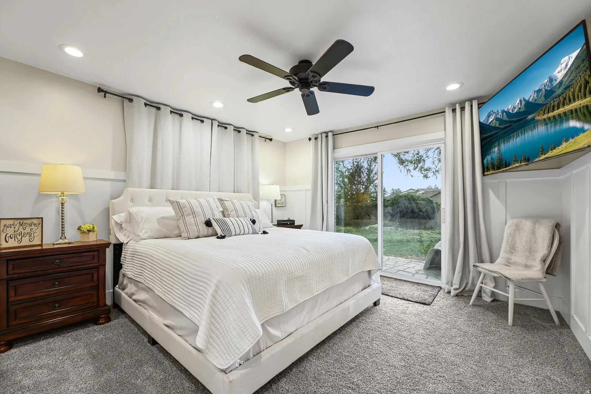 Primary bedroom with sliding glass door to backyard