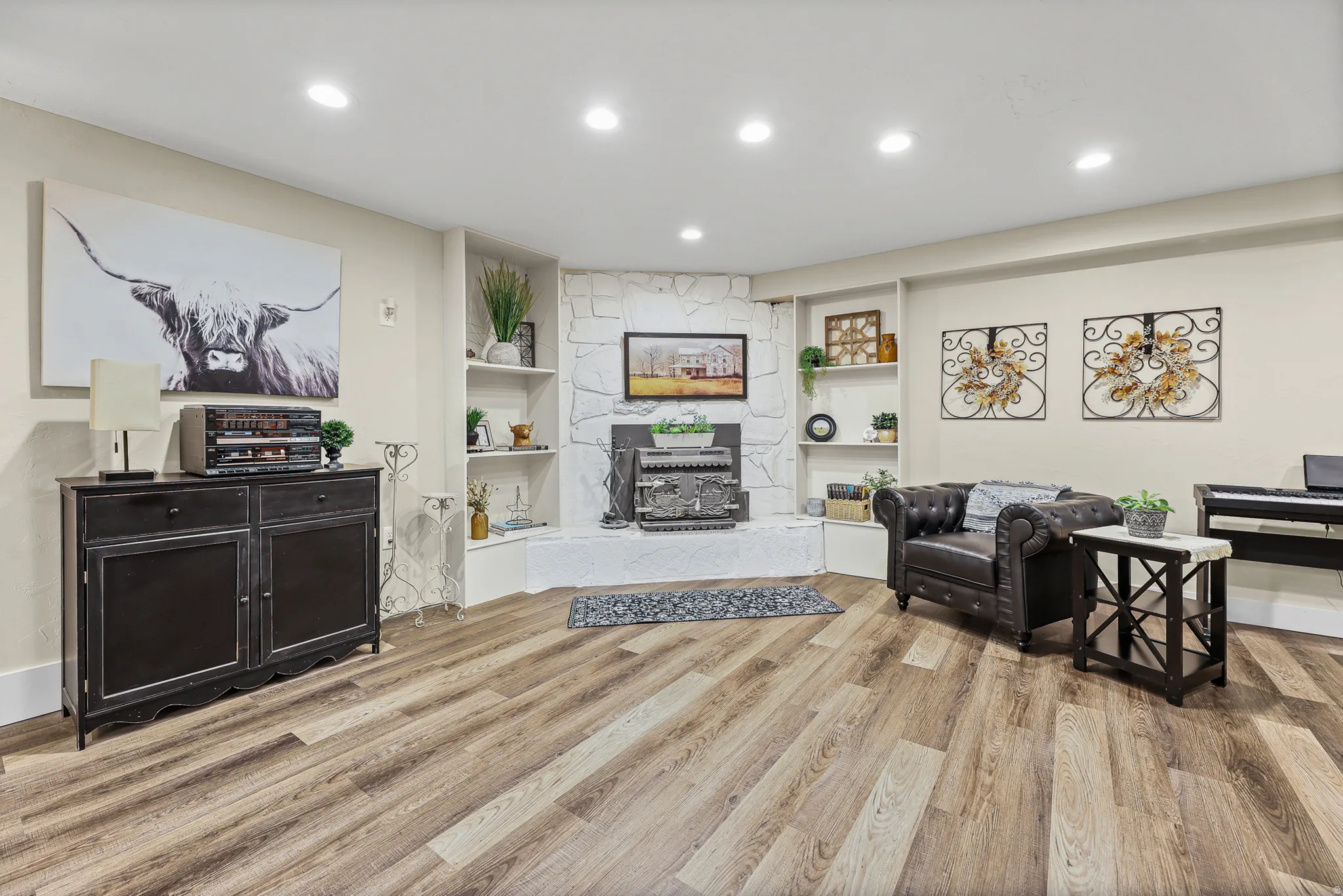 Spacious living area with stone fireplace and  built-in shelving