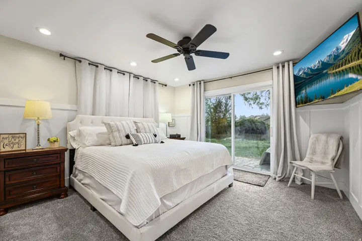 Primary bedroom with sliding glass door to backyard