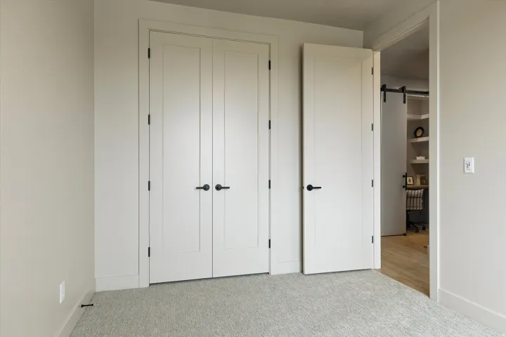 Neutral-toned walls complement light gray carpeting