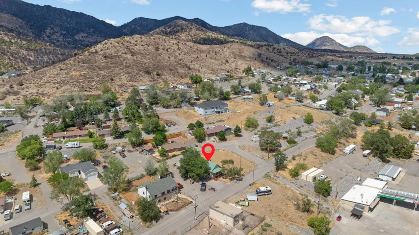 Aerial perspective showcasing a residential area nestled at the base of mountains