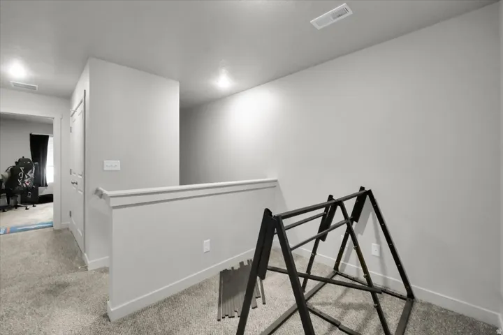 Upper-level hallway with light gray painted walls and matching trim