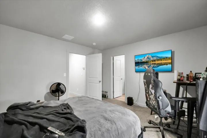 Spacious room featuring light gray walls, white trim, and a ceiling-mounted light fixture